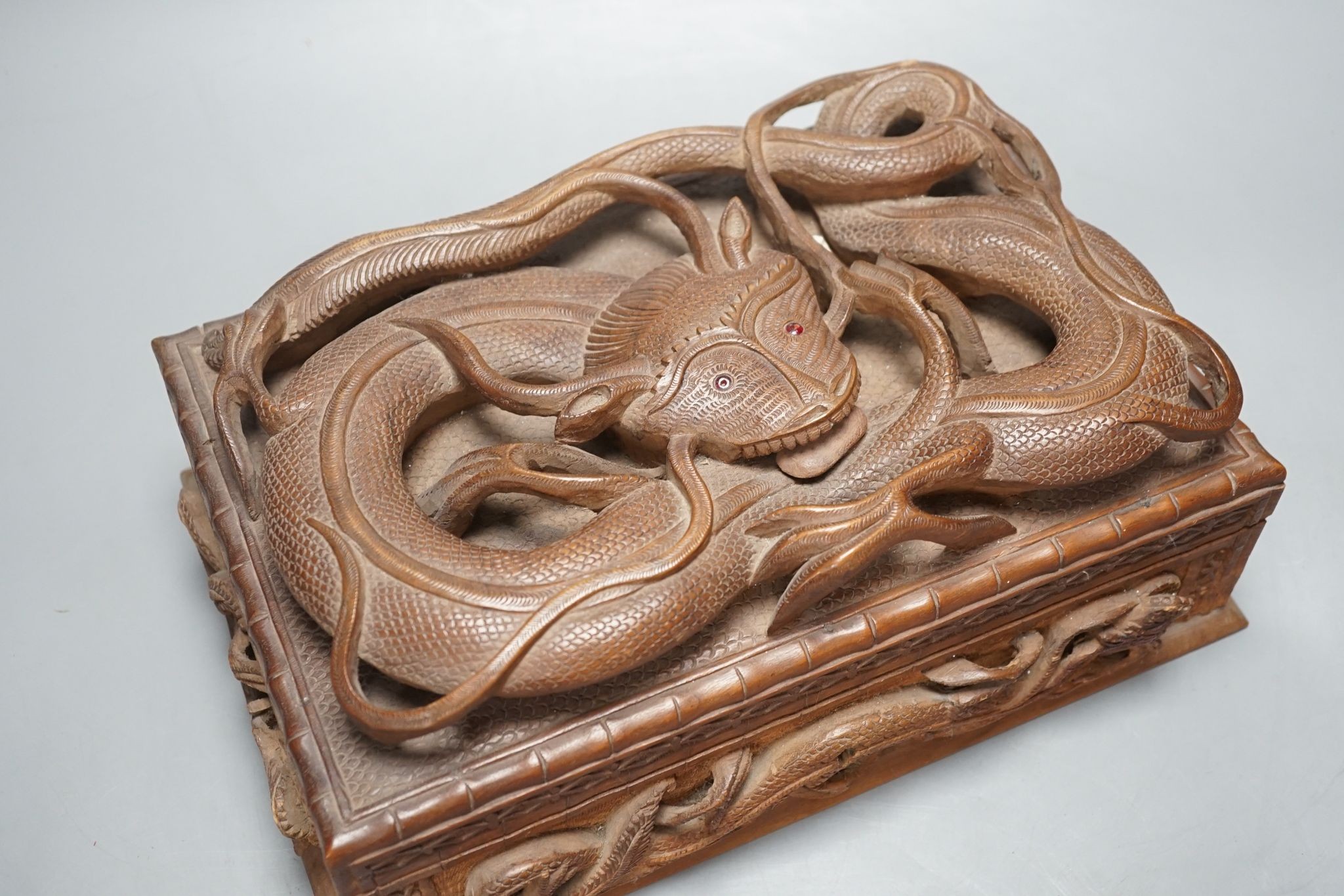 A Burmese carved wood 'Dragon' box, 31cm wide
